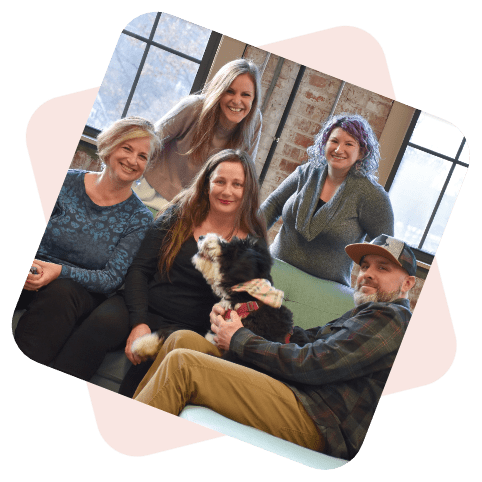 Ladybugz Interactive Team in a brick office with a dog.