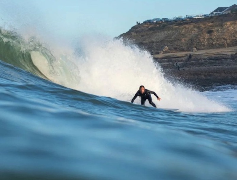 Alex Cachon, social media manager at Ladybugz Interactive, surfing in Spain.