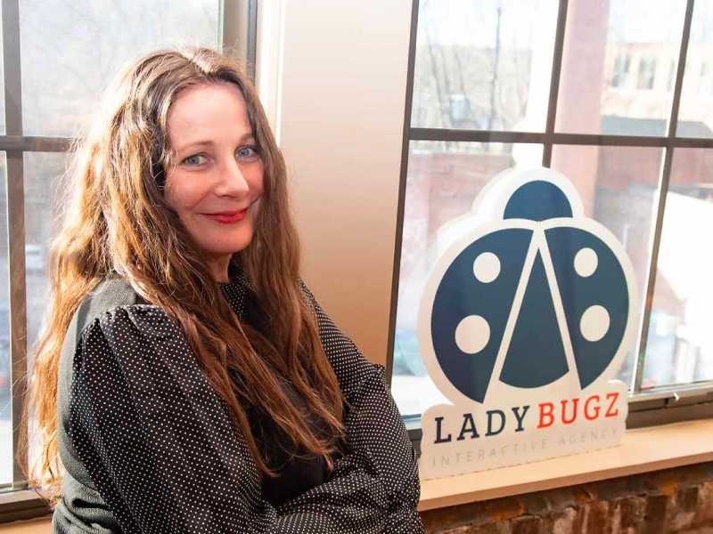 Lysa Miller, Founder & CEO of Ladybugz Interactive poses with official logo.