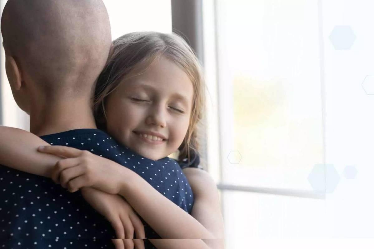 Genome Insight website photo of a person with cancer hugging a child
