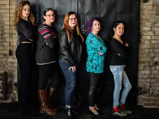 The women at Ladybugz Interactive Agency Boston, photo against a dark wall