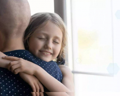 Genome Insight website photo of a person with cancer hugging a child