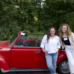 Lysa Miller and Ola Patykowski posing with the company vehicle.