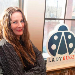 Lysa Miller, Founder & CEO of Ladybugz Interactive poses with official logo.