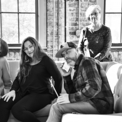 Ladybugz team members posing on the couch in the office.